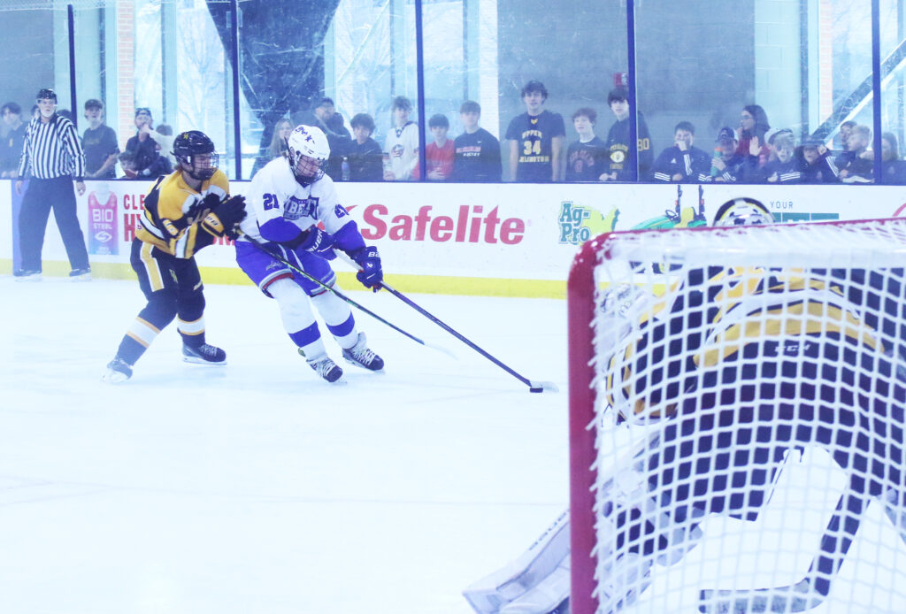 Liberty hockey Struck drives to net with puck