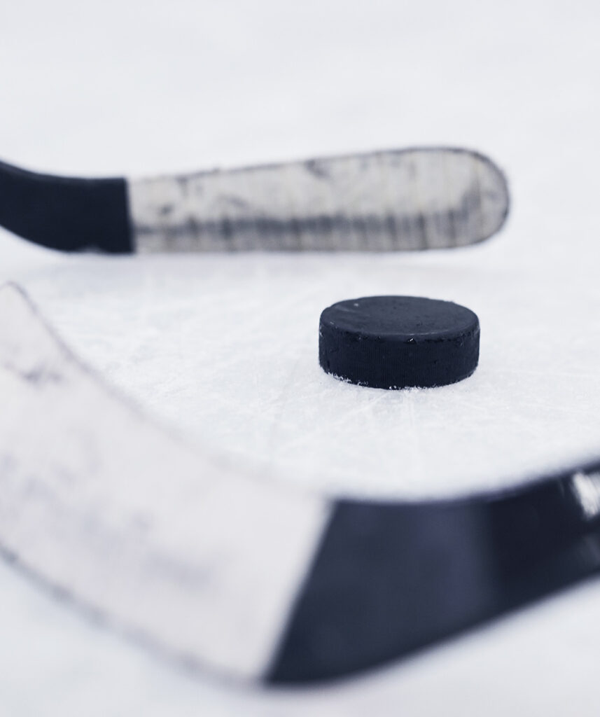 Hockey sticks and puck graphic