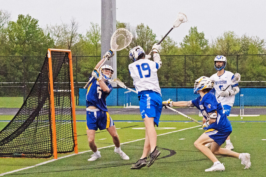 Hilliard Davidson's Evan Hughes shoots lacrosse ball