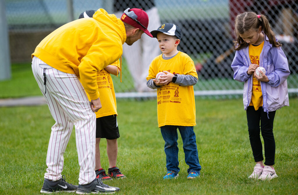 Westerville North head baseball coach Sean Ring greets cancer survivors