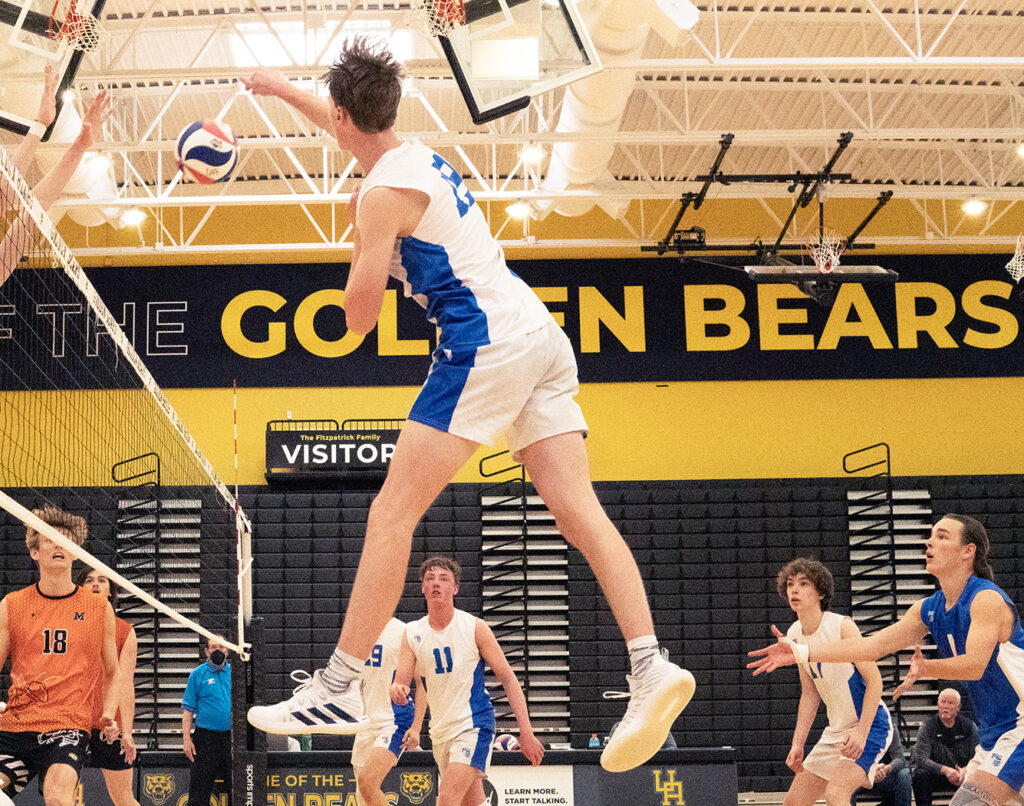 Olentangy Liberty's Caden Whiteside hits volleyball at net