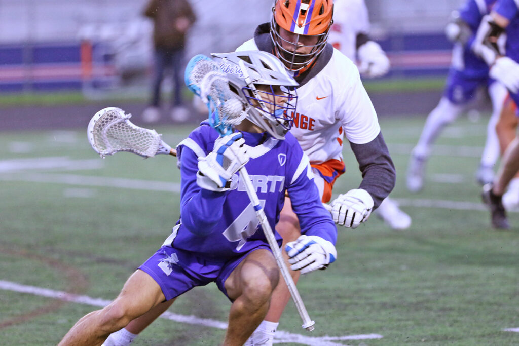 Olentangy Liberty boys lacrosse player Luca Minniti moves with ball