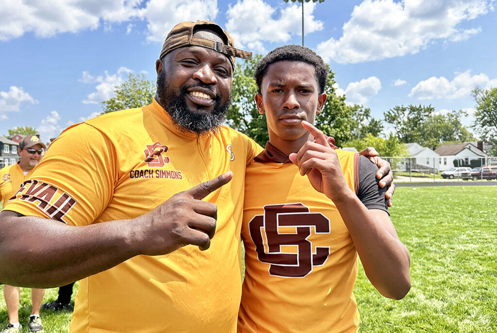 Beechcroft coach Humphrey Simmons and quarterback Aurelius Scott celebrate victory