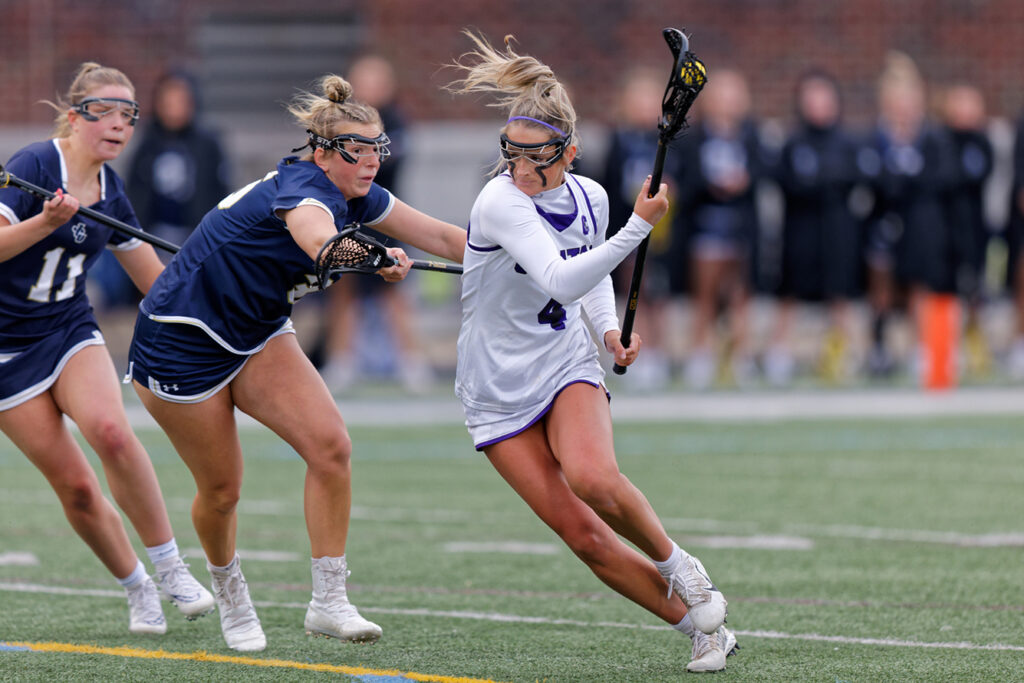 Capital's Grace Osborn dodges during lacrosse game