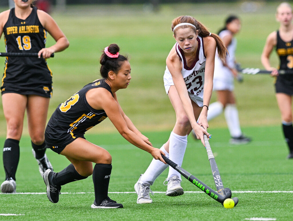 Columbus Academy and UA field hockey players compete for ball