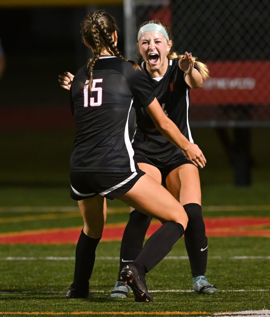 Worthington Christian girls soccer players celebrate goal