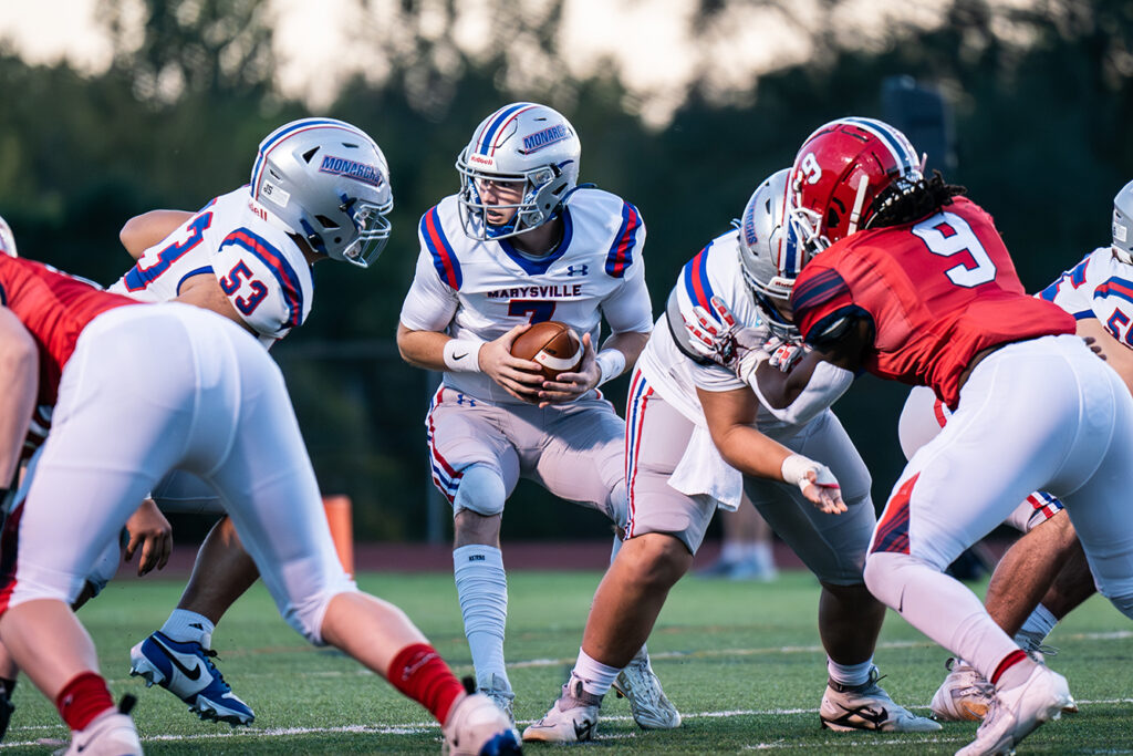 Marysville quarterback Brevin Bourquin takes snap