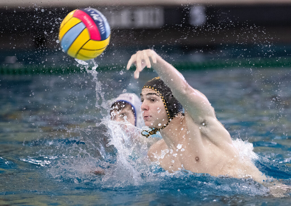 Upper Arlington’s Gabe Miller throws during water polo match