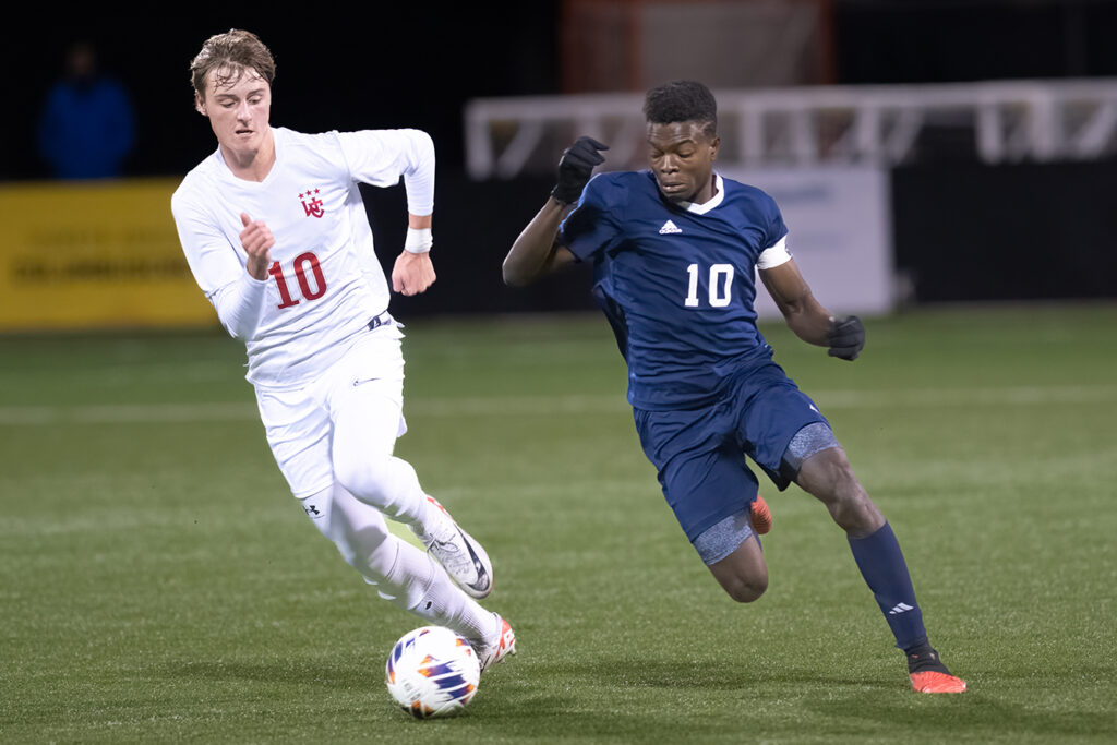 Worthington Christian's Caleb Van Dop battles for soccer ball