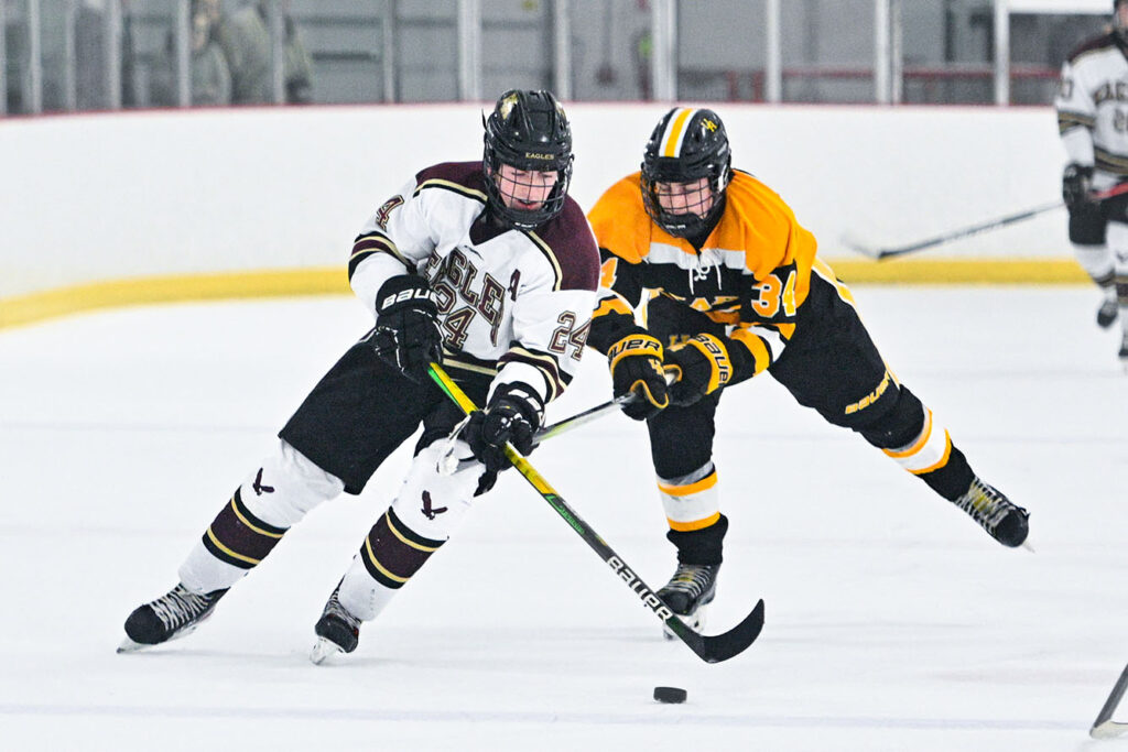 New Albany’s Jack Lower skates with puck