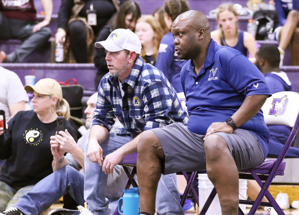 Teays Valley girls wrestling coaches beside the mat