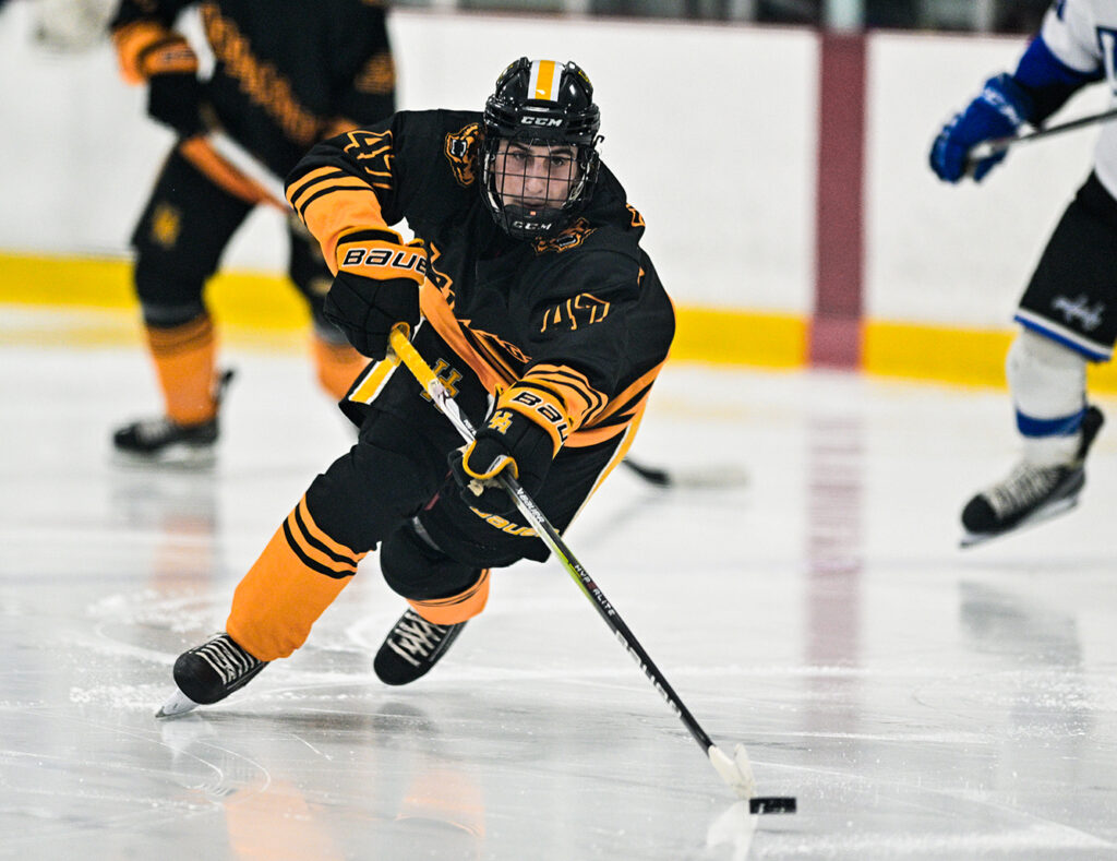 Upper Arlington’s Carter Shockley skates with puck