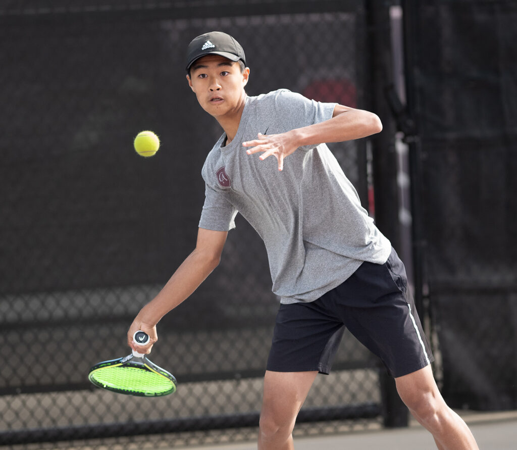 Academy's Lucas Xue hits tennis ball