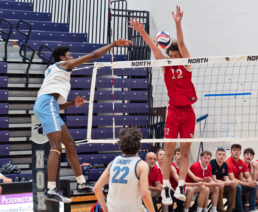 Hilliard Darby's Chris Jones hits at the net