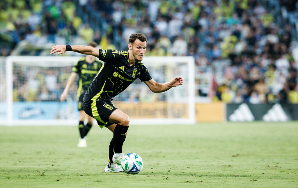 Crew Daniel Gazdag maneuvers with ball