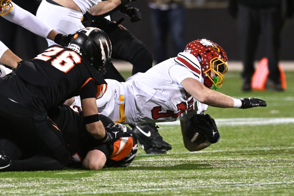 Big Walnut's Nolan Buirley reaches for yardage