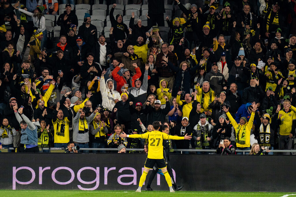 Crew's Max Arfsten celebrates with crowd