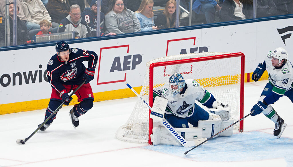 CBJ's Mathieu Olivier skates around net
