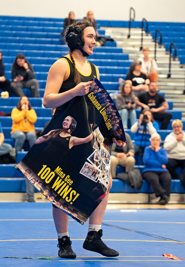 Gahanna's Mina Gee with 100-win poster