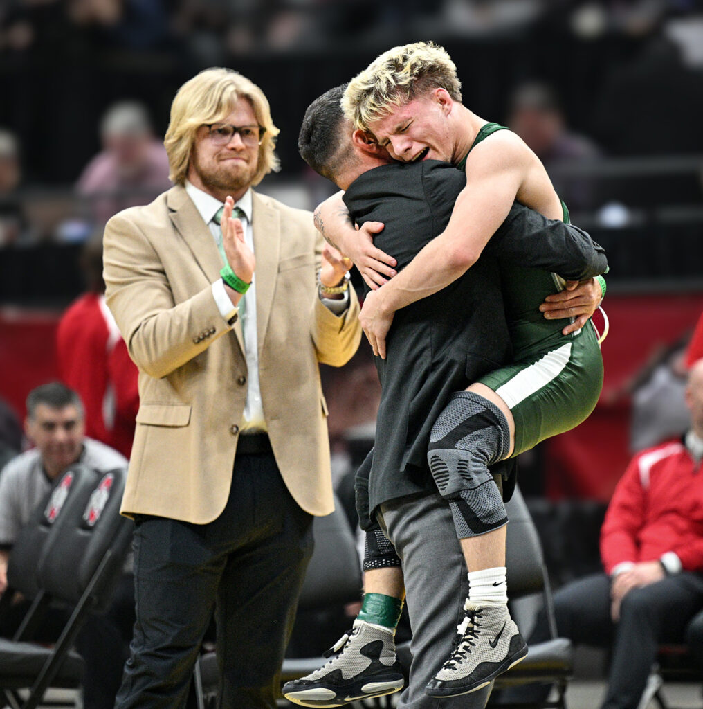 Coffman's Oliver Lester celebrates with coach