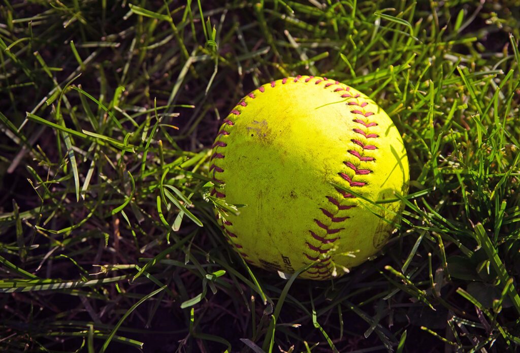Softball on grass graphic
