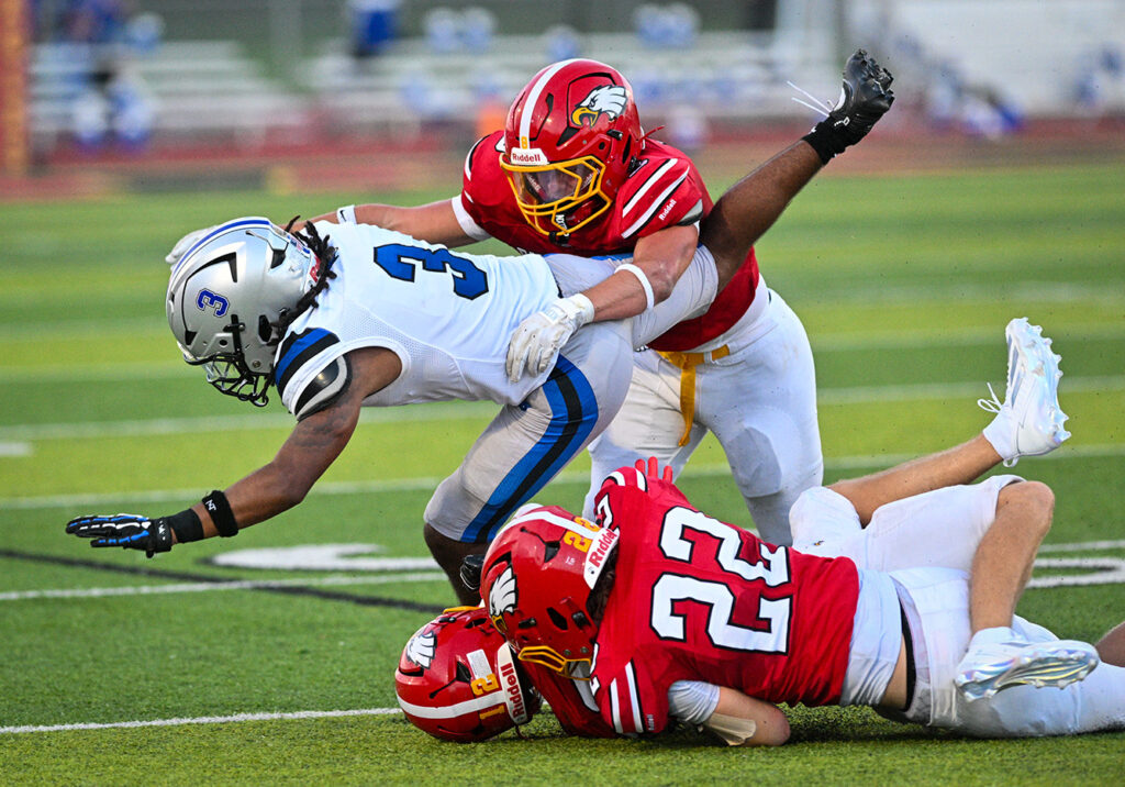 Big Walnut’s Cole Swonguer tackles Hilliard Bradley’s Bralyn Gordin.