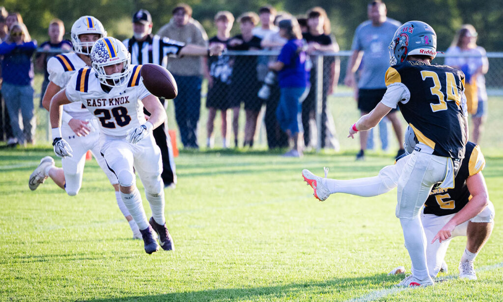 East Knox's Landon Boyd attempts to block kick