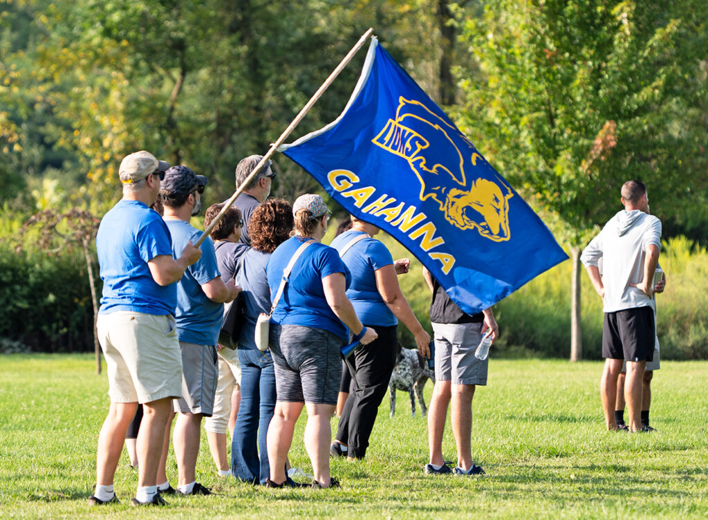 Gahanna girls cross country fans with flag