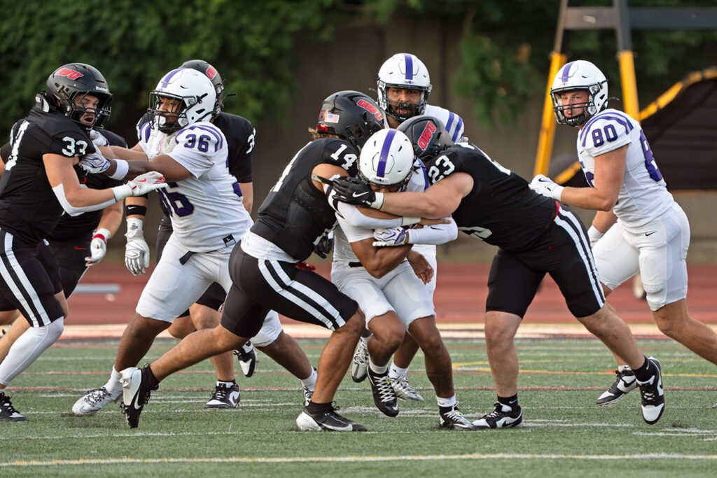 Ohio Wesleyan's Jordan Mills and Jacob Slyh make tackle
