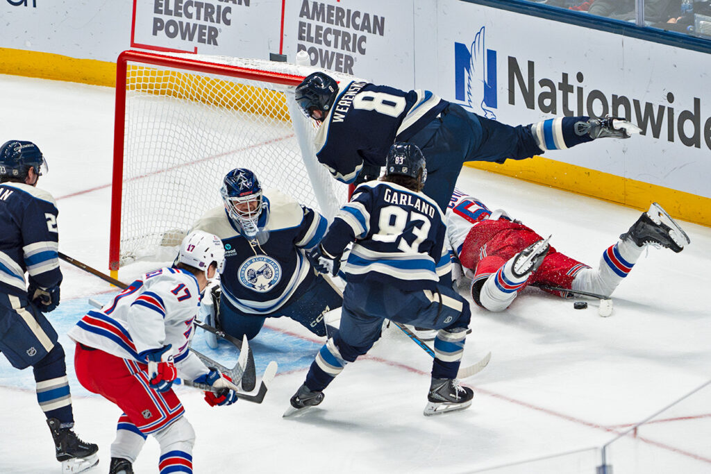 The Blue Jackets fly around to block a shot