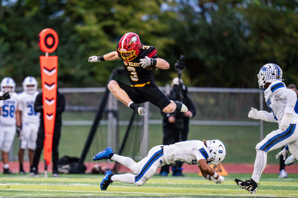 Big Walnut's Nolan Buirley jumps while running ball